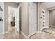 Bright hallway with wood-look tile flooring and white doors, offering a clean and modern aesthetic at 103 Reflection Cove Dr, Henderson, NV 89011