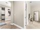 Neutral hallway showcasing wood floors, elegant décor, and access to the bath and bedrooms at 103 Reflection Cove Dr, Henderson, NV 89011