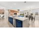 Spacious modern kitchen with an island, stainless steel appliances, and an open layout to the dining and living areas at 103 Reflection Cove Dr, Henderson, NV 89011