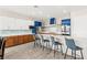Well-lit kitchen boasting modern cabinetry, stainless steel appliances, and breakfast bar seating at 103 Reflection Cove Dr, Henderson, NV 89011