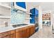 The kitchen features stainless steel appliances, stylish wooden cabinets, and a mosaic backsplash at 103 Reflection Cove Dr, Henderson, NV 89011