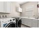 Well-equipped laundry room with modern washer and dryer at 103 Reflection Cove Dr, Henderson, NV 89011