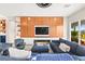 Modern living room featuring custom wood paneling, fireplace, and access to outdoor pool area at 103 Reflection Cove Dr, Henderson, NV 89011