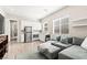 Open-concept living area featuring a modern kitchen, stylish sofa, and wood-look floors at 103 Reflection Cove Dr, Henderson, NV 89011