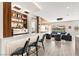 Open-concept living area with a bar, stylish seating, and scenic views, perfect for entertaining guests at 103 Reflection Cove Dr, Henderson, NV 89011