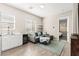 Cozy living room with a wet bar, comfortable seating, and natural light from the window at 103 Reflection Cove Dr, Henderson, NV 89011