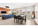 Bright living area with a fireplace, a comfortable blue sofa, and mountain views from the sliding doors at 103 Reflection Cove Dr, Henderson, NV 89011