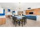 Open-concept living space including the dining room, living room and kitchen with modern finishes and wood flooring at 103 Reflection Cove Dr, Henderson, NV 89011