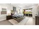 Relaxing main bedroom with sliding glass doors to the patio, a large bed, and mountain views at 103 Reflection Cove Dr, Henderson, NV 89011