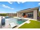 Backyard oasis featuring a pool, spa, and covered patio with ample seating at 103 Reflection Cove Dr, Henderson, NV 89011