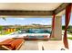 Covered pool area with outdoor seating and mountain views at 103 Reflection Cove Dr, Henderson, NV 89011