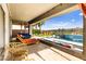 Inviting covered patio with outdoor seating and a stunning pool with waterfall feature at 103 Reflection Cove Dr, Henderson, NV 89011
