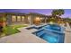 Expansive backyard with sparkling pool, putting green, outdoor seating, and mature landscaping for ultimate relaxation at 103 Reflection Cove Dr, Henderson, NV 89011