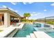 Resort-style pool with waterfall, spa, and outdoor lounge area with comfortable seating at 103 Reflection Cove Dr, Henderson, NV 89011