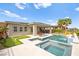Exterior view of a home featuring a pool, outdoor seating, and lush landscaping at 103 Reflection Cove Dr, Henderson, NV 89011