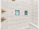 Elegant walk-in shower with wall niches, bench and sleek fixtures, offering spa-like experience at 103 Reflection Cove Dr, Henderson, NV 89011