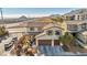Inviting two-story home has a tile roof, three-car garage, with attractive landscaping and nearby highway access at 10611 Auburn Springs Ave, Las Vegas, NV 89166
