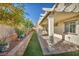 Outdoor patio with covered pergola, artificial turf, and landscaped retaining wall at 10611 Auburn Springs Ave, Las Vegas, NV 89166
