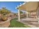 Backyard patio with covered pergola, artificial turf, and a tiered garden bed at 10611 Auburn Springs Ave, Las Vegas, NV 89166