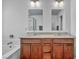 Bright bathroom with double sinks, wood cabinets, quartz countertops, and a separate tub and shower at 10611 Auburn Springs Ave, Las Vegas, NV 89166