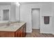 Stylish bathroom featuring double sinks, wood cabinets, quartz countertops and modern fixtures at 10611 Auburn Springs Ave, Las Vegas, NV 89166
