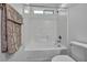 Bright bathroom with a white tiled shower-tub combo at 10611 Auburn Springs Ave, Las Vegas, NV 89166