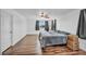 Bedroom featuring wood-look floors, a ceiling fan, window views, and a comfortable bed at 10611 Auburn Springs Ave, Las Vegas, NV 89166