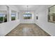 Bright dining room featuring tile flooring and a modern chandelier at 10611 Auburn Springs Ave, Las Vegas, NV 89166