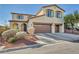 Inviting two-story home with manicured landscaping, terracotta roof tiles and attached two car garage at 10611 Auburn Springs Ave, Las Vegas, NV 89166