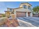 Charming two-story home features a two-car garage, desert landscaping, and arched front porch at 10611 Auburn Springs Ave, Las Vegas, NV 89166
