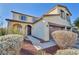 Charming two-story home features an arched front porch, desert landscaping, and a dark front door at 10611 Auburn Springs Ave, Las Vegas, NV 89166
