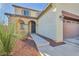 Charming two-story home features an arched front porch, desert landscaping, and a decorative security door at 10611 Auburn Springs Ave, Las Vegas, NV 89166