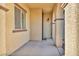This covered front porch is tiled and has an exterior wall sconce light at 10611 Auburn Springs Ave, Las Vegas, NV 89166