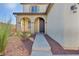 The arched front porch has decorative pillars and a modern security door at 10611 Auburn Springs Ave, Las Vegas, NV 89166