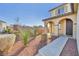 The front yard features desert landscaping, arched entry, and a modern front door at 10611 Auburn Springs Ave, Las Vegas, NV 89166