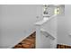Bright hallway with wood floors, white walls and stair railing, and a view to the living space beyond at 10611 Auburn Springs Ave, Las Vegas, NV 89166