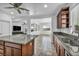 This kitchen has an island with seating, granite counters, stainless appliances, and recessed lighting at 10611 Auburn Springs Ave, Las Vegas, NV 89166