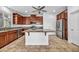Spacious kitchen featuring dark wood cabinets, granite countertops, stainless steel appliances, and a center island at 10611 Auburn Springs Ave, Las Vegas, NV 89166