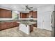 This kitchen features granite counters, stainless appliances, and an island with a breakfast bar at 10611 Auburn Springs Ave, Las Vegas, NV 89166