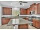 This kitchen features granite counters, stainless appliances, and an island with a breakfast bar at 10611 Auburn Springs Ave, Las Vegas, NV 89166