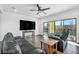 Bright living room features modern ceiling fan, recessed lighting, and sliding door access to the outdoor patio at 10611 Auburn Springs Ave, Las Vegas, NV 89166
