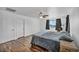Relaxing main bedroom with natural light, ceiling fan, wood floors and neutral decor, inviting comfort and style at 10611 Auburn Springs Ave, Las Vegas, NV 89166