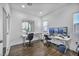 Well-lit office space featuring two workstations, hardwood floors, and plenty of natural light at 10611 Auburn Springs Ave, Las Vegas, NV 89166