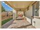 Covered patio with brick flooring, ceiling fan, and views of the landscaped backyard at 10611 Auburn Springs Ave, Las Vegas, NV 89166