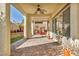 Covered patio with brick flooring, offering a relaxing outdoor space overlooking lush landscaping at 10611 Auburn Springs Ave, Las Vegas, NV 89166