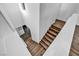 Modern staircase with hardwood steps and white walls offers a stylish transition between floors at 10611 Auburn Springs Ave, Las Vegas, NV 89166