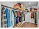 Organized walk-in closet featuring wooden floors, hanging clothes, and shelf storage with boxes at 10611 Auburn Springs Ave, Las Vegas, NV 89166