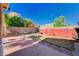 Enclosed backyard with a patio, block wall, and mature trees at 11117 Romola St, Las Vegas, NV 89141