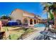 Expansive backyard featuring a large pool, covered patio, and lush landscaping at 11117 Romola St, Las Vegas, NV 89141