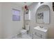 Cozy half-bathroom with a modern sink, toilet, and built-in cabinet at 11117 Romola St, Las Vegas, NV 89141